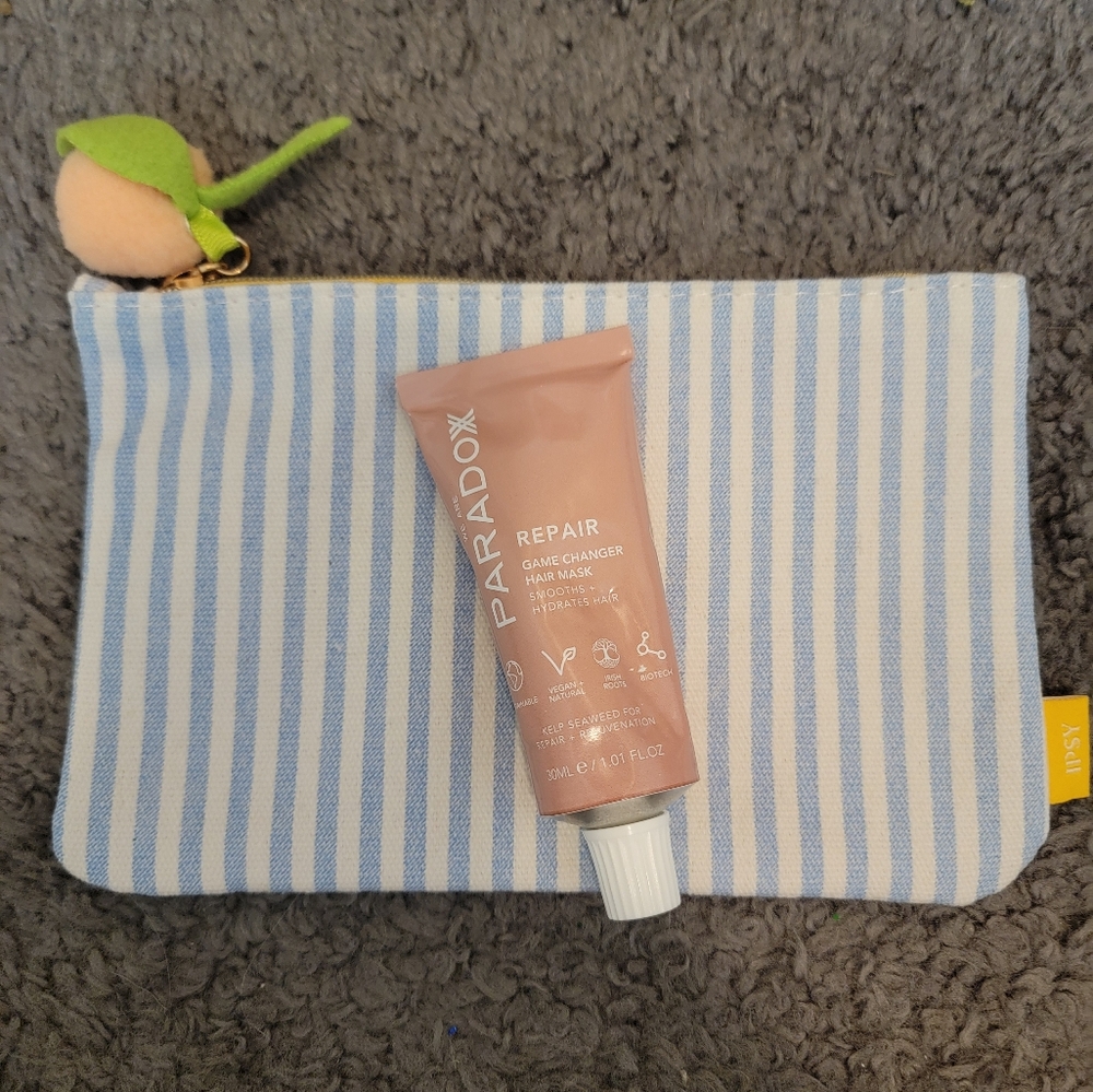 Ipsy striped bag with Paradox Repair Game changer hair mask